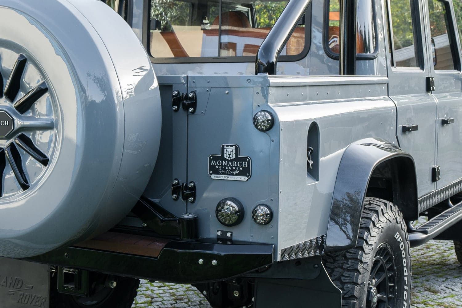 Detail Shot: Custom Rear Styling Close-up of a bespoke Land Rover Defender's rear with Monarch Defender branding and custom features