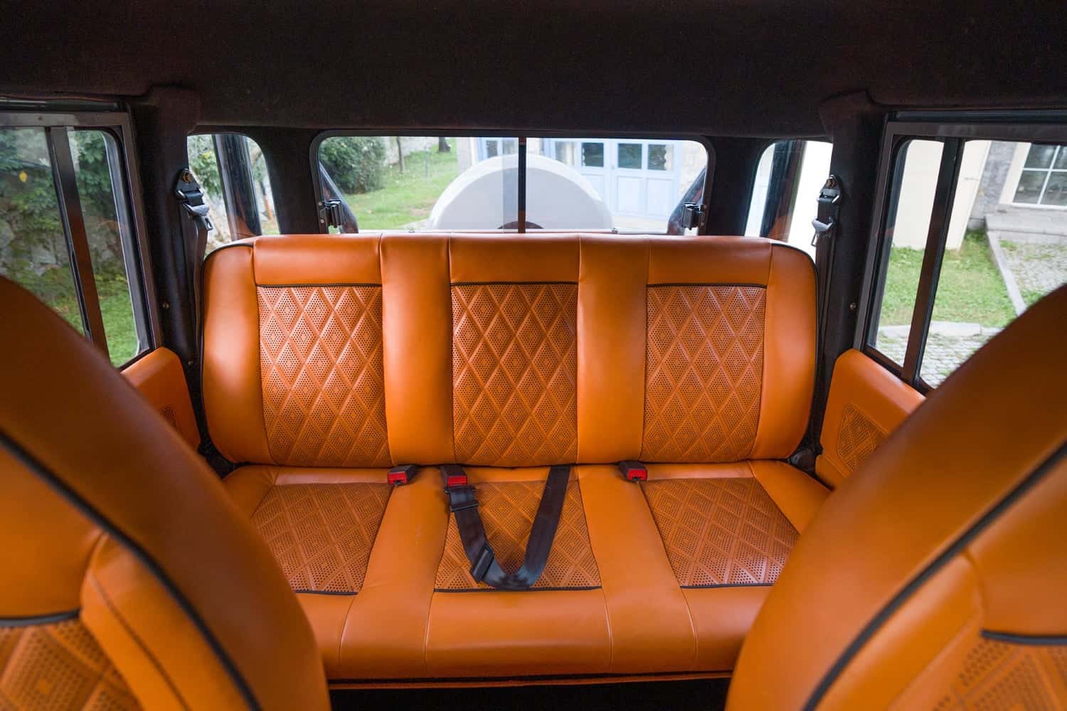 Interior Shot: Luxurious Rear Seating Custom Land Rover Defender rear seating in rich orange leather