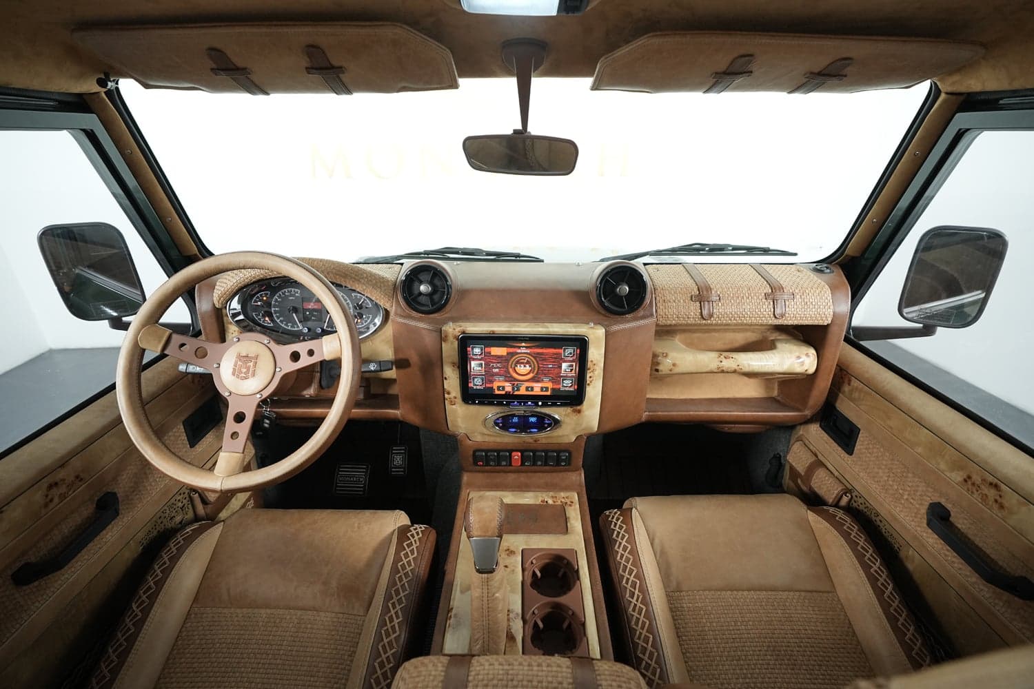 Interior Shot: Luxury Cabin Bespoke interior of a custom Land Rover Defender with premium materials and modern technology