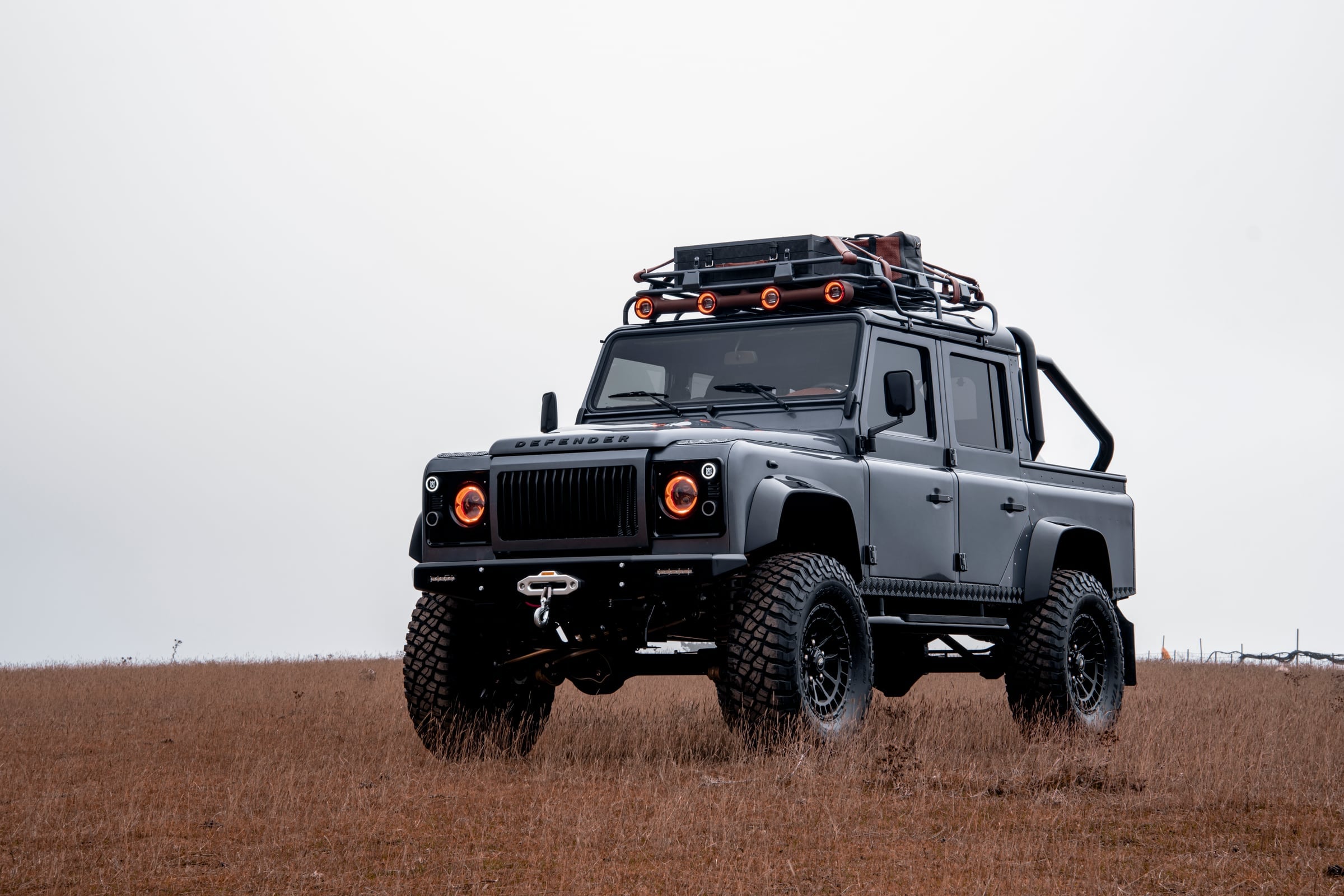 Action Shot: Custom Land Rover Defender Bespoke Land Rover Defender in a rugged outdoor setting