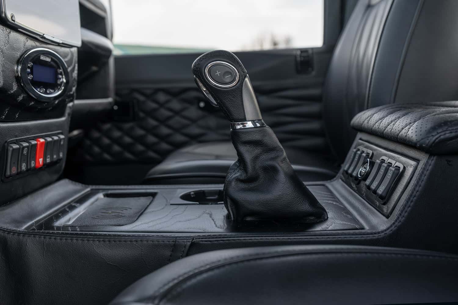 Interior Shot: Custom Gear Shift Interior view of a bespoke Land Rover Defender featuring a custom gear shift in black leather
