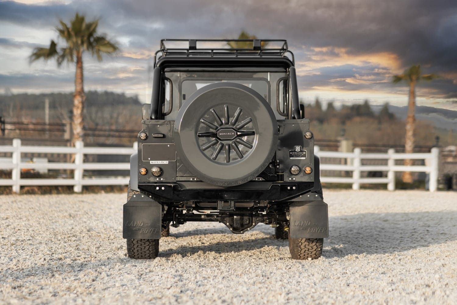 Rear View: Bespoke Land Rover Defender Rear view of a custom Monarch Defender with a mounted spare tire, showcasing luxury and off-road capabilities.