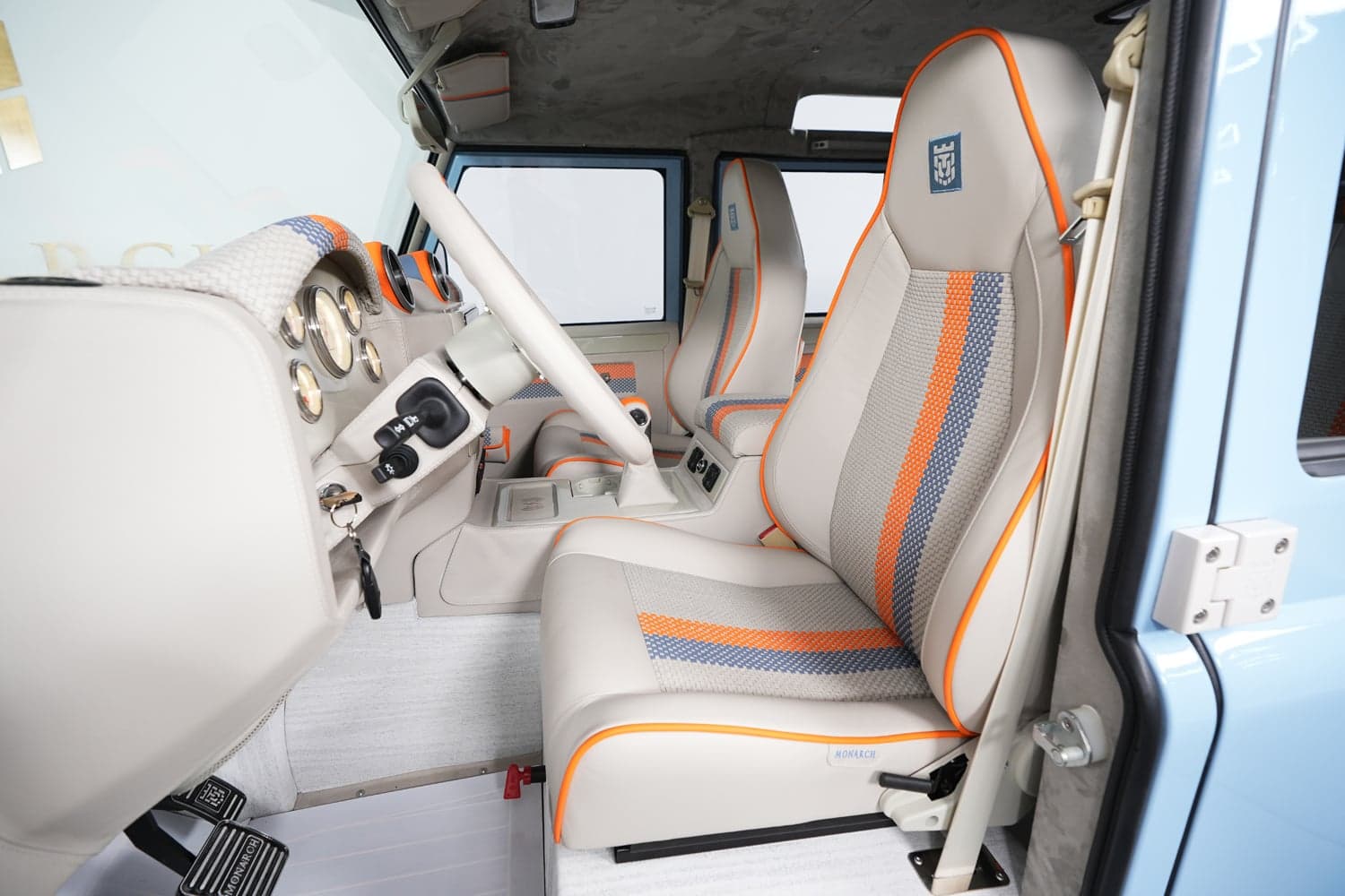 Interior Shot: Bespoke Seating Luxury custom Land Rover Defender interior with premium seats in beige and orange accents