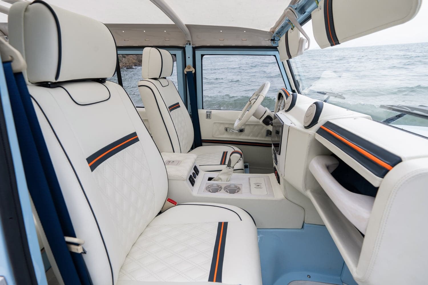 Interior Shot: Luxury Cabin Design Interior of a luxury custom Land Rover Defender with white leather seats and modern dashboard