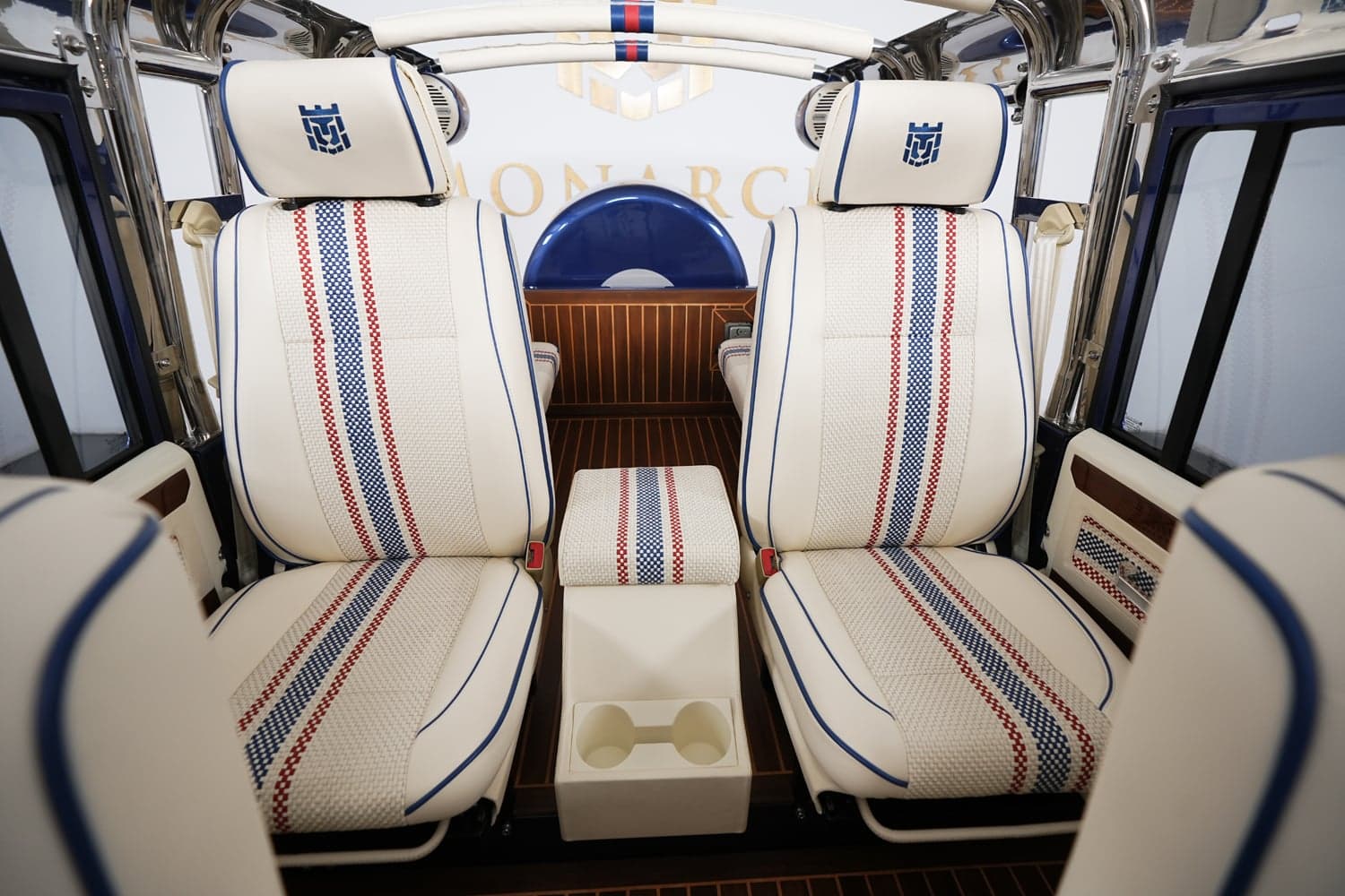 Interior Shot: Bespoke Seating Design Interior of a luxury custom Land Rover Defender with white leather seats featuring red and blue stripes