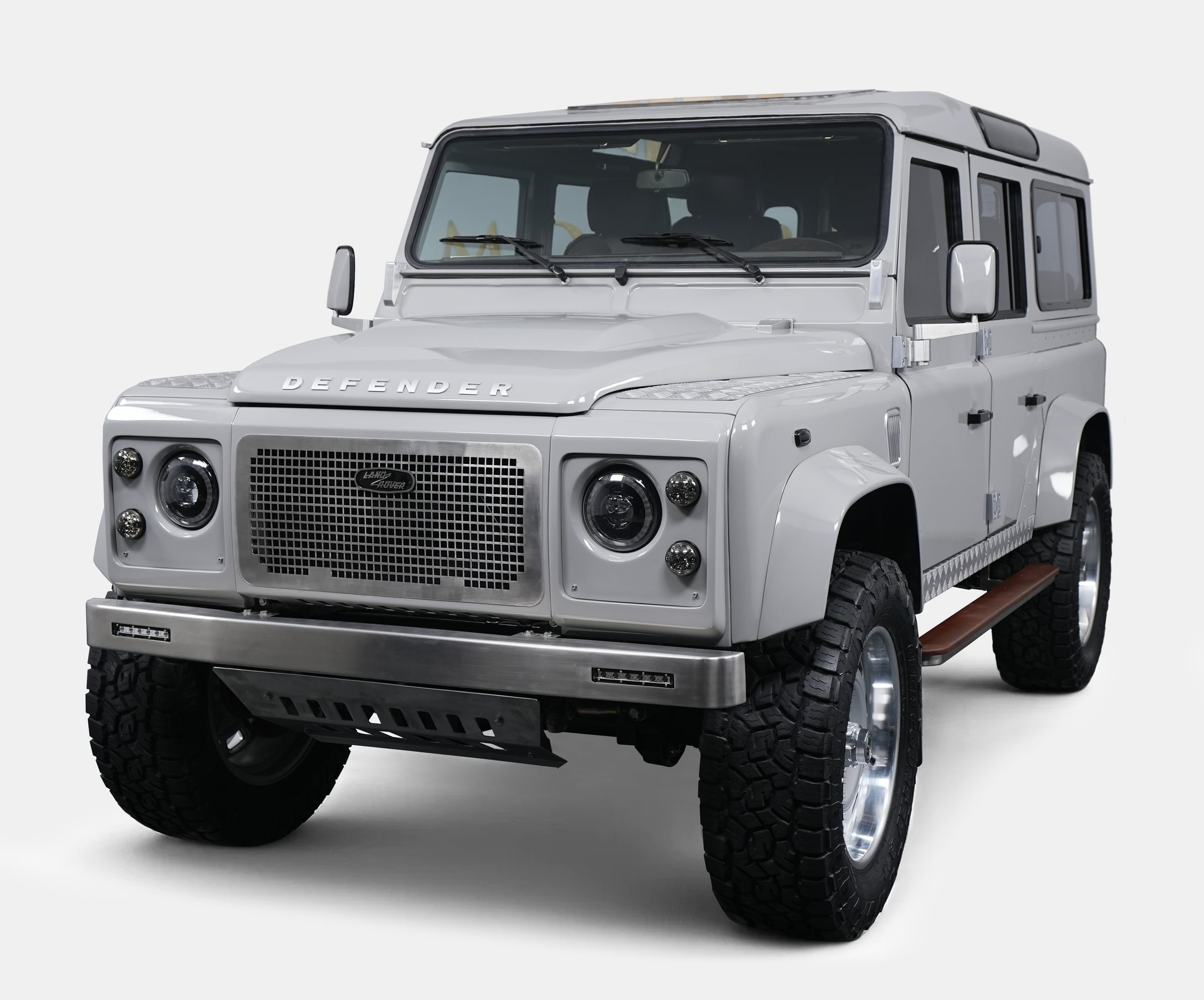 Front View: Bespoke Land Rover Defender Luxury custom Land Rover Defender in white with aggressive stance and modern styling