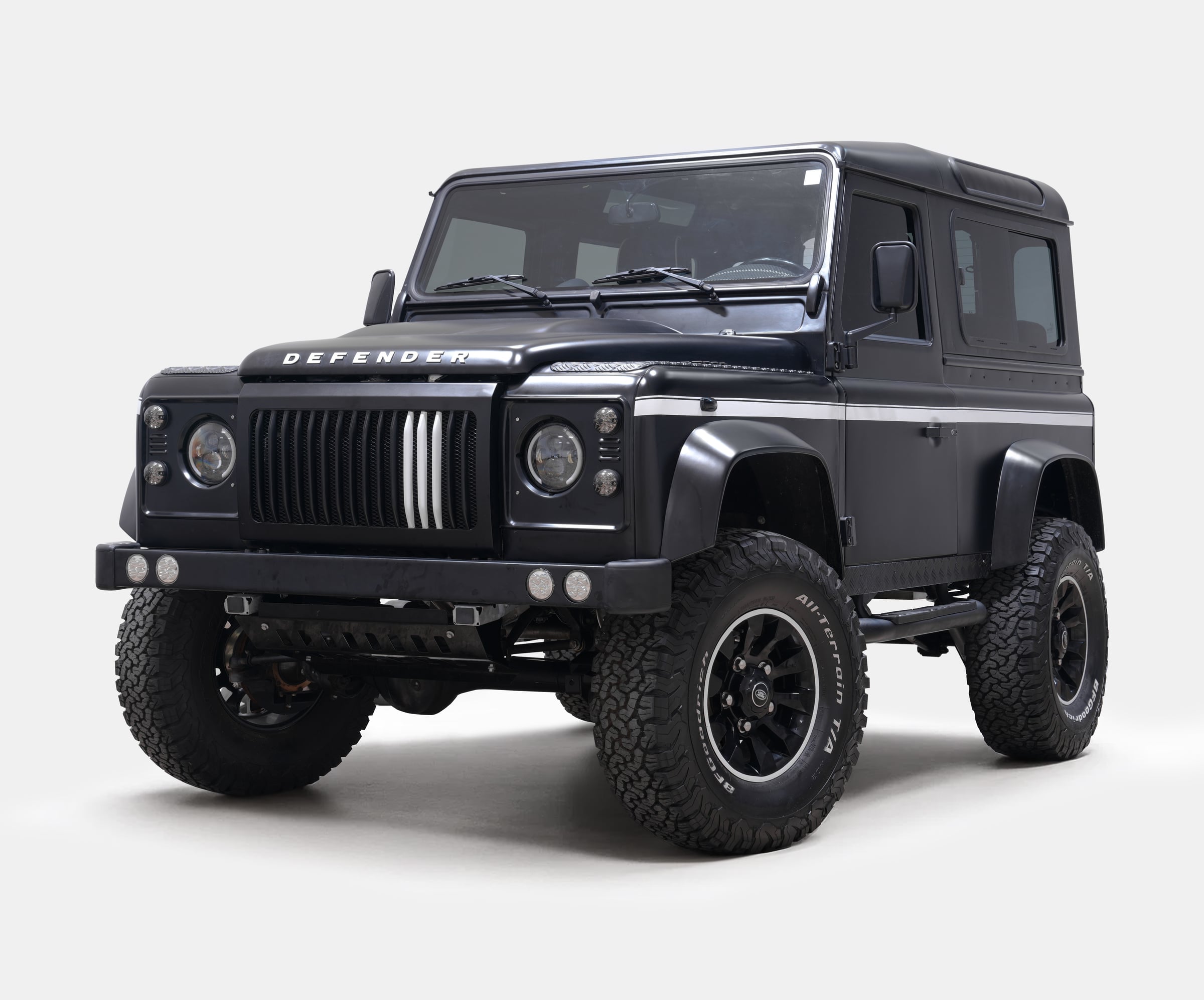 Custom Land Rover Defender in matte black with rugged tires Custom Land Rover Defender in matte black with rugged tires