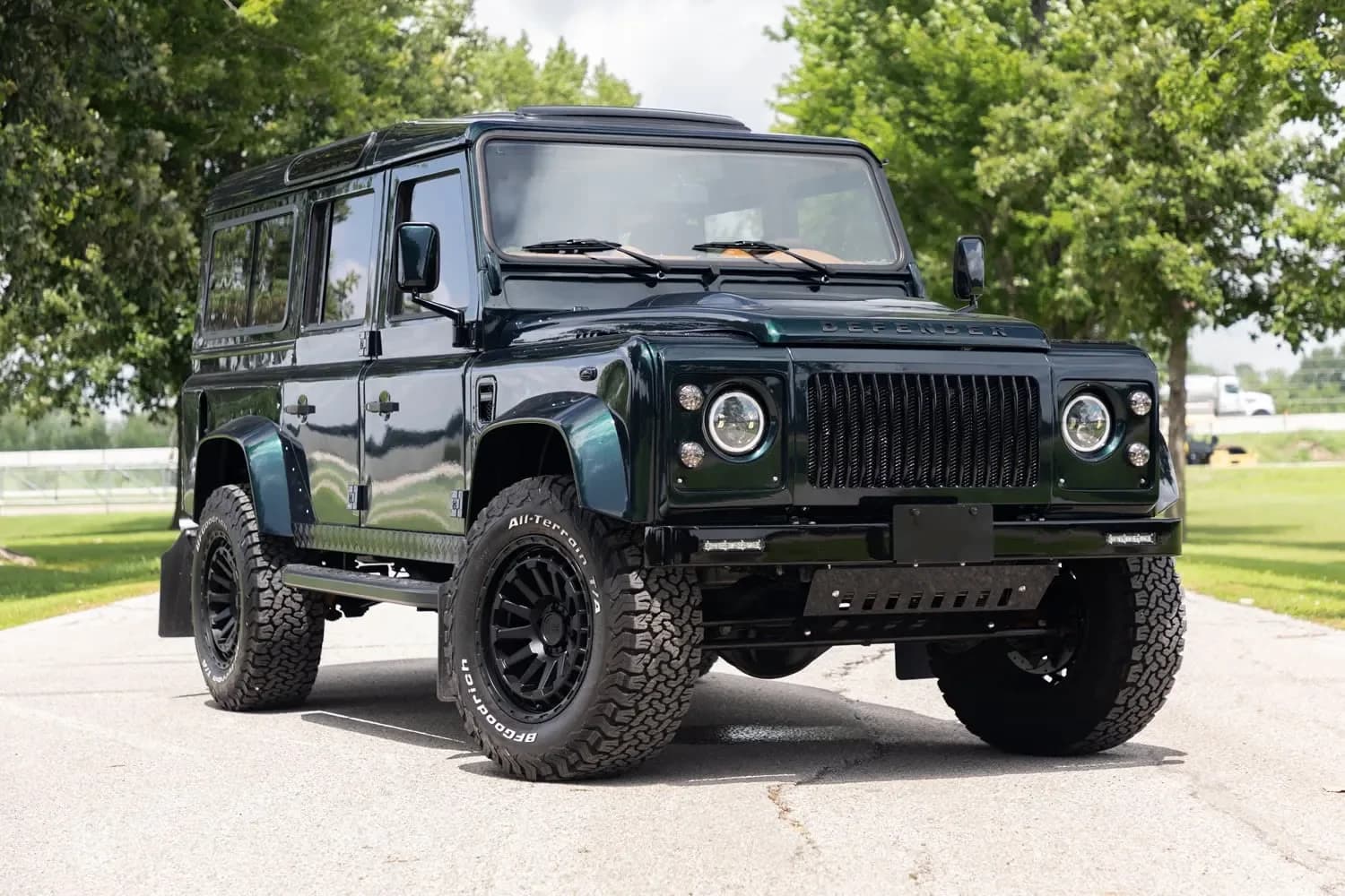 A classic Defender 110 mid-build in green, showing a restored defender