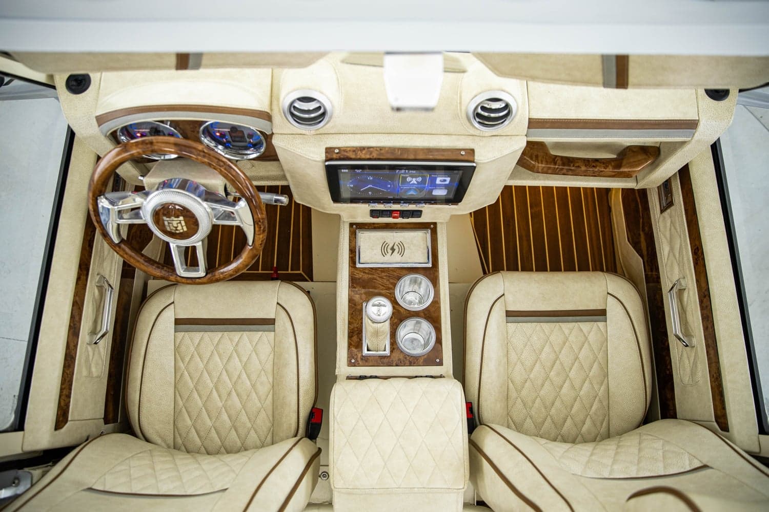 Wide shot of a luxury Defender interior showing hand-stitched Italian leather seats, modern touchscreen, and billet aluminum switchgear