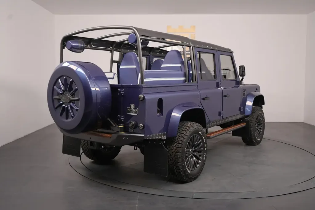 a blue defender 110 on a circular platform